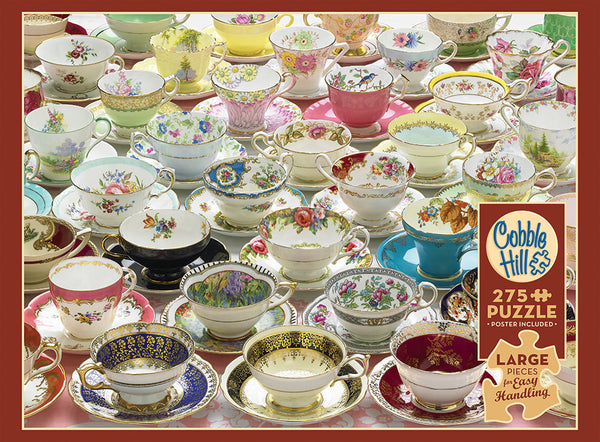 A colorful collection of vintage tea cups and saucers with intricate floral and decorative designs, arranged closely together on a wooden surface.