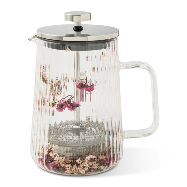 Clear ribbed glass French press with stainless steel lid and handle, containing dried pink and beige flowers inside for a decorative touch.