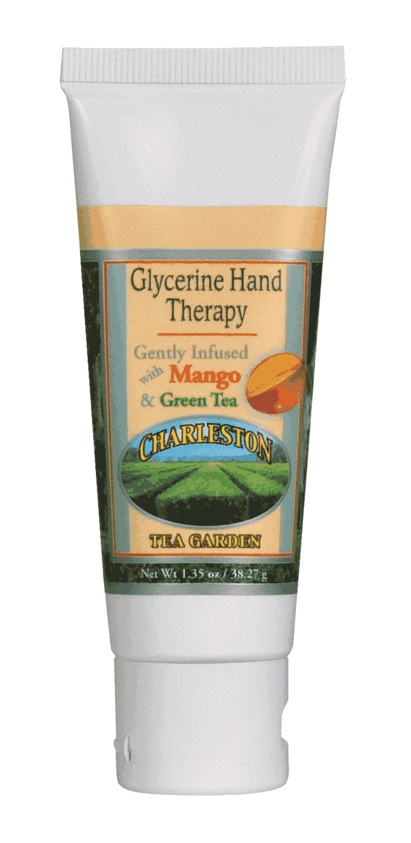 Tube of glycerine hand therapy lotion infused with mango and green tea, featuring a Charleston Tea Garden label with a scenic tea field illustration.