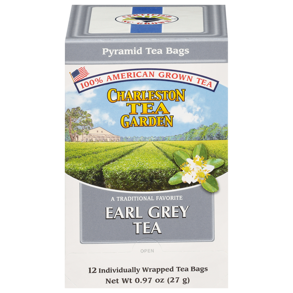 Box of Charleston Tea Garden’s Earl Grey Pyramid tea bags featuring a scenic view of tea fields under a blue sky and a blooming tea flower on the front.