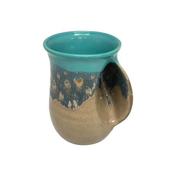 Ceramic handwarmer mug with a smooth turquoise rim and speckled blue and tan glaze, designed to comfortably warm hands while enjoying a hot beverage.