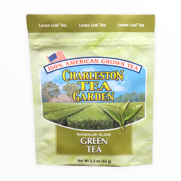 Package of Charleston Tea Garden loose leaf green tea, featuring an image of lush tea fields under a blue sky, highlighting 100% American grown tea.