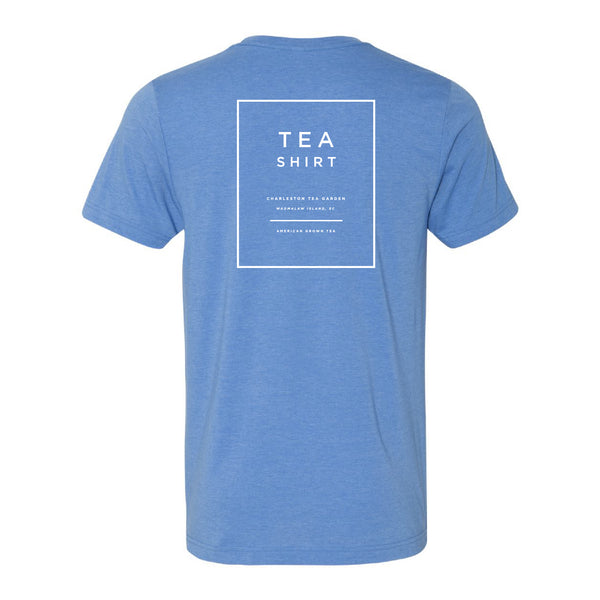 Back view of a comfortable heathered blue T-shirt featuring a simple white square design with the words "Tea Shirt" and Charleston Tea Garden branding, perfect for casual wear.