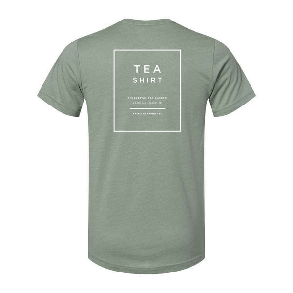 Back view of a heather sage green casual t-shirt featuring a simple white design with text promoting Charleston Tea Garden and American grown tea.