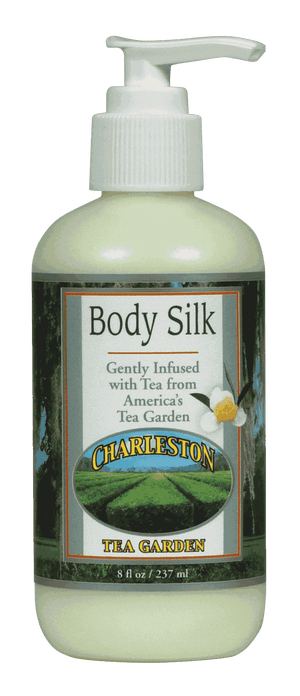 Bottle of Body Silk lotion infused with tea from Charleston Tea Garden, featuring a pump dispenser and a label showing tea fields and a flower.
