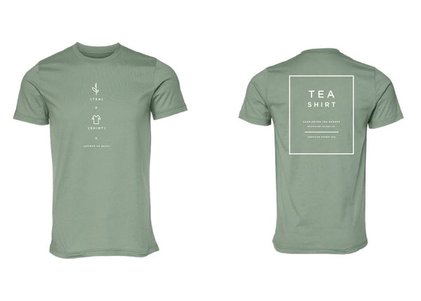 Heather sage green t-shirt with minimalist white tea-inspired graphics on front and "TEA SHIRT" text with Charleston Tea Garden reference on the back.