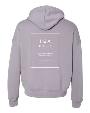Light gray fleece hoodie with a simple back design featuring text related to Charleston Tea Garden and American brown tea, perfect for comfortable casual wear.