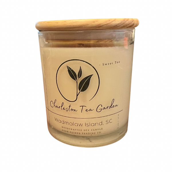 Glass jar candle with a wooden lid, featuring a sweet tea scent and labeled with Charleston Tea Garden from Wadmalaw Island, South Carolina.