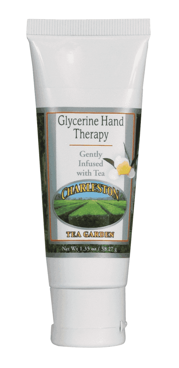 Small white tube of glycerine hand therapy cream infused with tea, featuring a green tea garden image and floral design on the label.