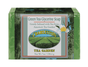 Bar of green tea glycerine soap gently infused with tea from Charleston Tea Garden, wrapped in packaging featuring an image of tea fields and a white flower.