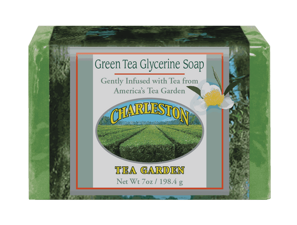 Bar of green tea glycerine soap gently infused with tea from Charleston Tea Garden, wrapped in packaging featuring an image of tea fields and a white flower.