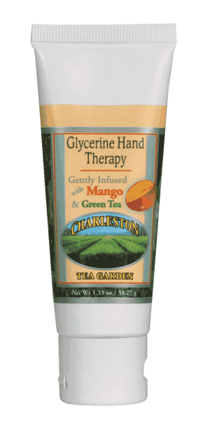 Tube of glycerine hand therapy lotion infused with mango and green tea, featuring a Charleston Tea Garden label with a scenic tea field illustration.
