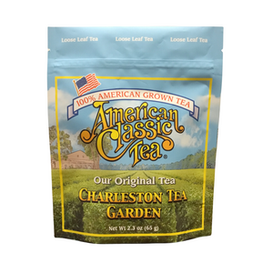 Package of American Classic Tea loose leaf tea featuring Charleston Tea Garden branding with a scenic field background under a blue sky.