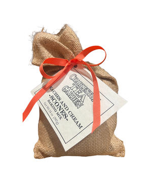 Small burlap sack tied with a bright orange ribbon, labeled for peaches and cream scones mix from Charleston Tea Garden.