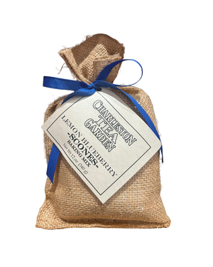 Small burlap sack tied with a blue ribbon, containing lemon blueberry scone mix from Charleston Tea Garden, showcasing rustic and charming packaging.