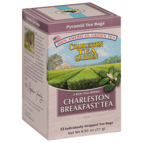 Box of Charleston Breakfast Pyramid tea bags featuring vibrant green tea fields and a clear blue sky in the background, highlighting American-grown loose leaf tea.