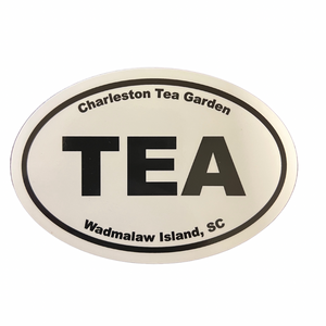 Oval bumper sticker with bold black text reading "TEA" in the center, surrounded by "Charleston Tea Garden" at the top and "Wadmalaw Island, SC" at the bottom on a white background.