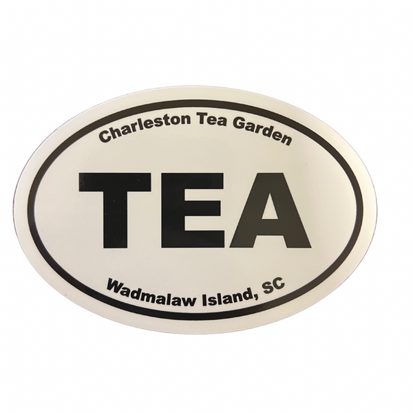 Oval bumper sticker with bold black text reading "TEA" in the center, surrounded by "Charleston Tea Garden" at the top and "Wadmalaw Island, SC" at the bottom on a white background.