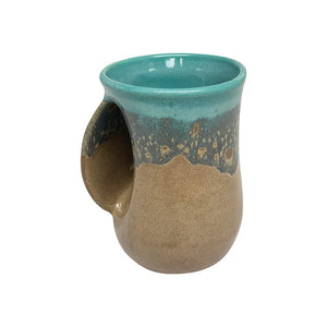 Handcrafted ceramic handwarmer mug with a smooth earthy brown and turquoise glaze, shaped for comfort and warmth while enjoying a hot beverage.
