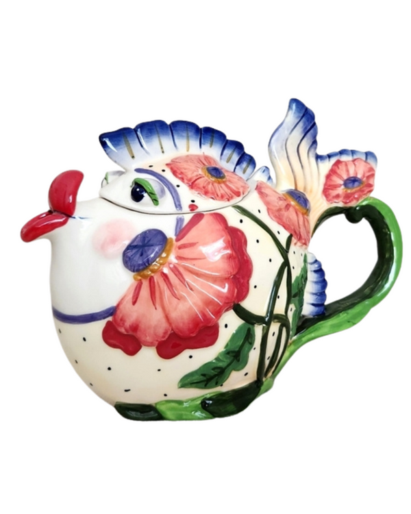 Colorful ceramic teapot shaped like a whimsical fish with floral patterns, vivid red lips, blue fins, and a green handle, perfect as a charming tea accessory or souvenir.