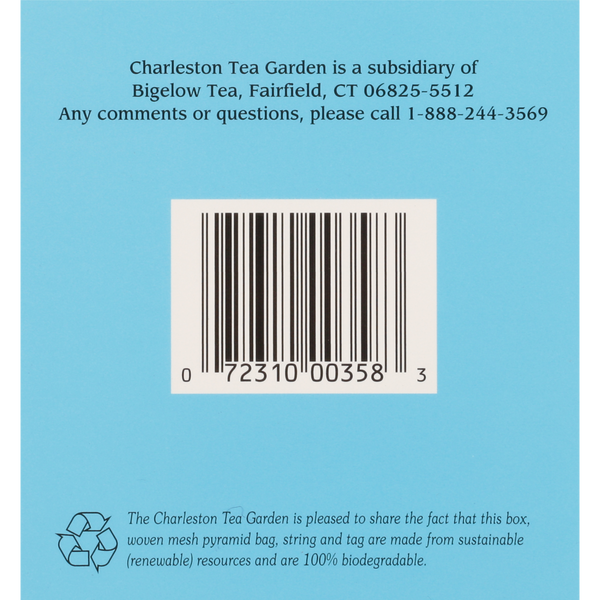 Barcode on a blue background with text about Charleston Tea Garden being a subsidiary of Bigelow Tea, including contact information and a note about the biodegradable, sustainable materials used in the packaging.