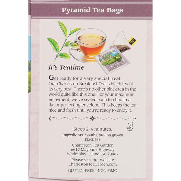 A box showing pyramid-shaped tea bags and a cup of clear amber tea, with text describing Charleston Breakfast black tea made from South Carolina grown leaves, highlighting freshness and quality.