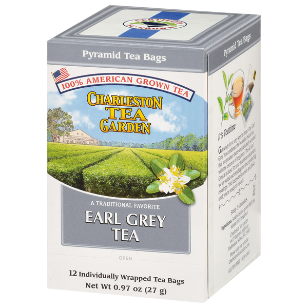 Box of Charleston Tea Garden Earl Grey Pyramid tea bags featuring an illustrated tea field, white tea flowers, and a cup of brewed tea on the side panel.