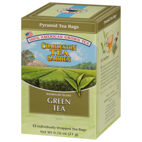 Box of pyramid-shaped green tea bags from Charleston Tea Garden featuring American-grown tea and a scenic tea field illustration on the packaging.