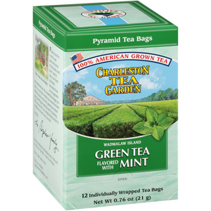Box of Charleston Tea Garden green tea flavored with mint, featuring pyramid tea bags made from 100% American-grown tea, with an illustration of lush tea fields and fresh mint leaves.