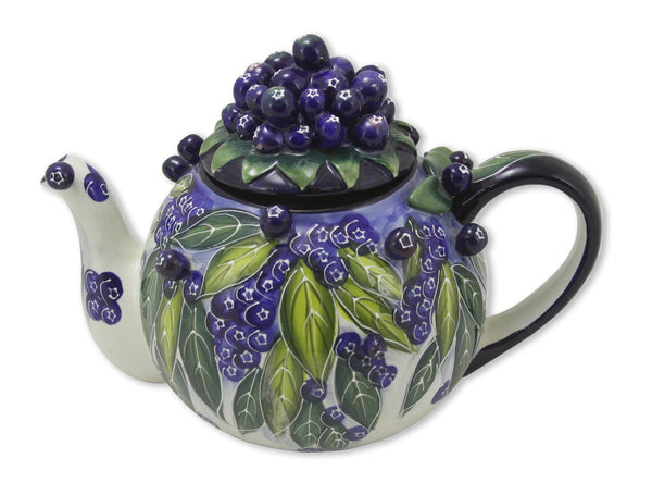 Hand-painted ceramic teapot decorated with vibrant blueberries and green leaves, featuring a cluster of blueberries on the lid and a comfortable handle.