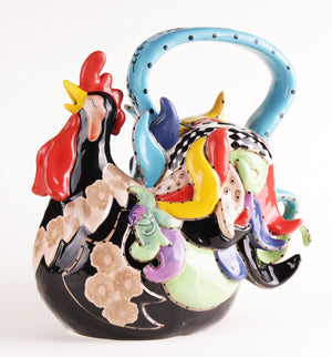 Colorful ceramic teapot shaped like a playful black rooster with bright red, yellow, blue, and pastel accents on a white background.