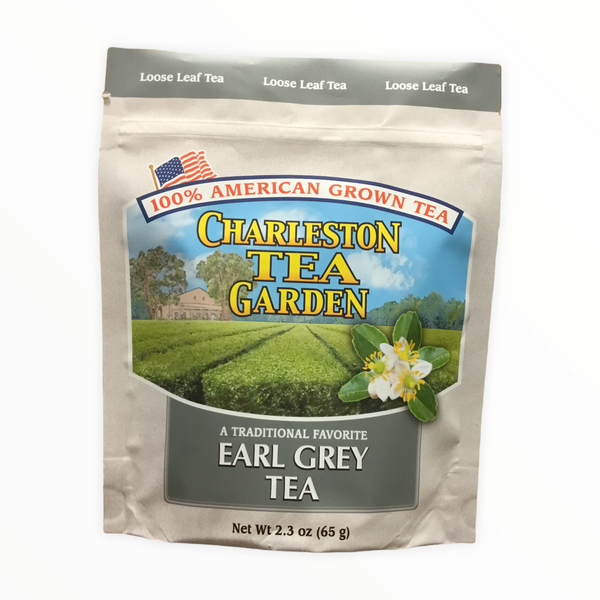 Pouch of loose leaf Earl Grey tea from Charleston Tea Garden with American flag, green tea fields, and tea blossoms on the packaging.